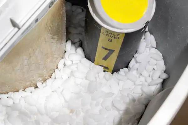 In Monticello, MN, a water softener tank filled with salt pellets shows the salt level indicator marked at 7, ensuring your system works efficiently. If the levels fluctuate unexpectedly, it might be time to consider water softener repair for optimal performance.